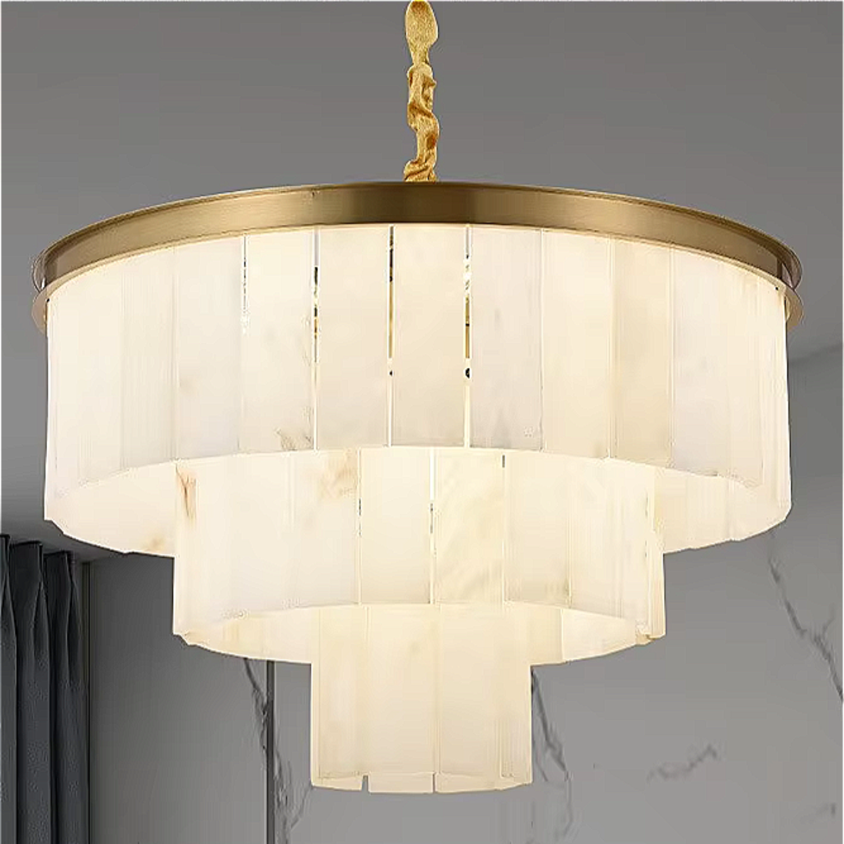 Close-up of layered marble chandelier tiers with soft warm lighting and brushed gold frame | LINKORI TRUPIKA
