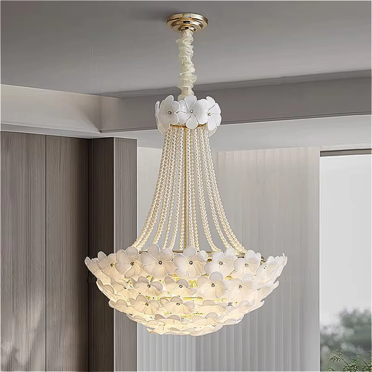Wide interior shot of a modern living room featuring a sculptural flower chandelier, with a close-up showcasing its delicate white petals and pearl chains.