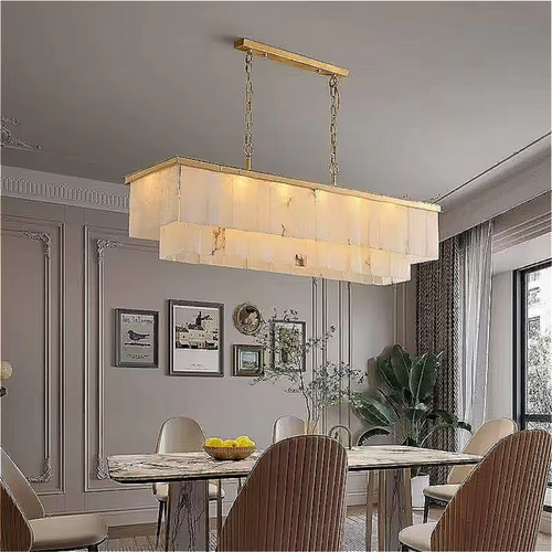 Rectangular marble chandelier suspended over a luxury dining table, featuring a 2-tier natural marble design and copper crown.