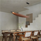Organic walnut chandelier illuminating a wooden dining table in a Japandi-style living room
