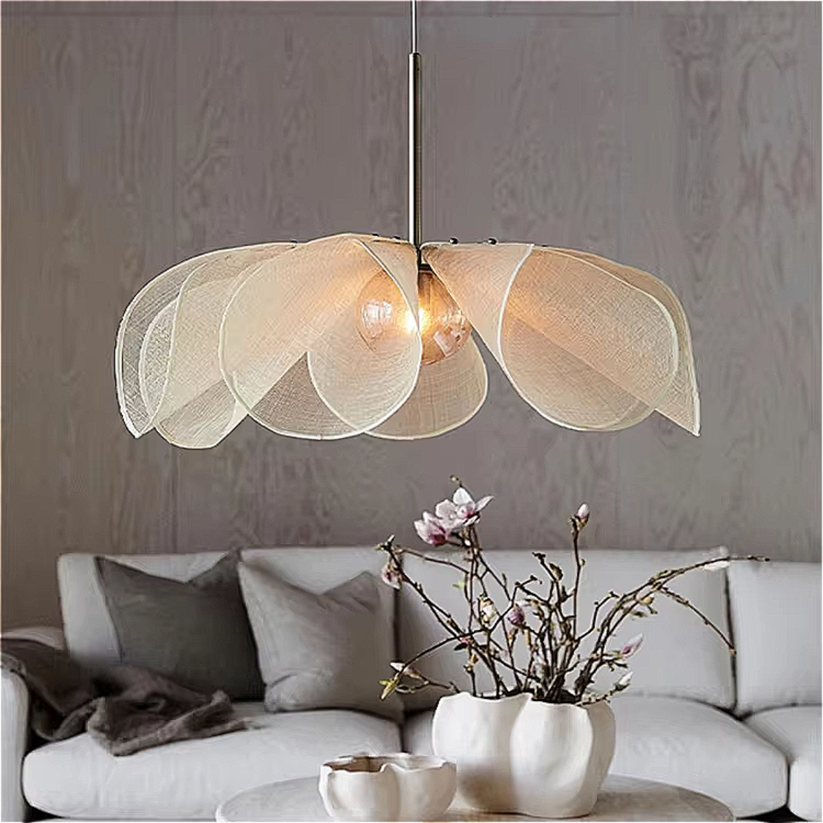 Sculptural natural fiber chandelier above soft neutral-toned Japandi sofa – artistic organic lighting for serene interiors | LINKORI PETALIQ Embrace