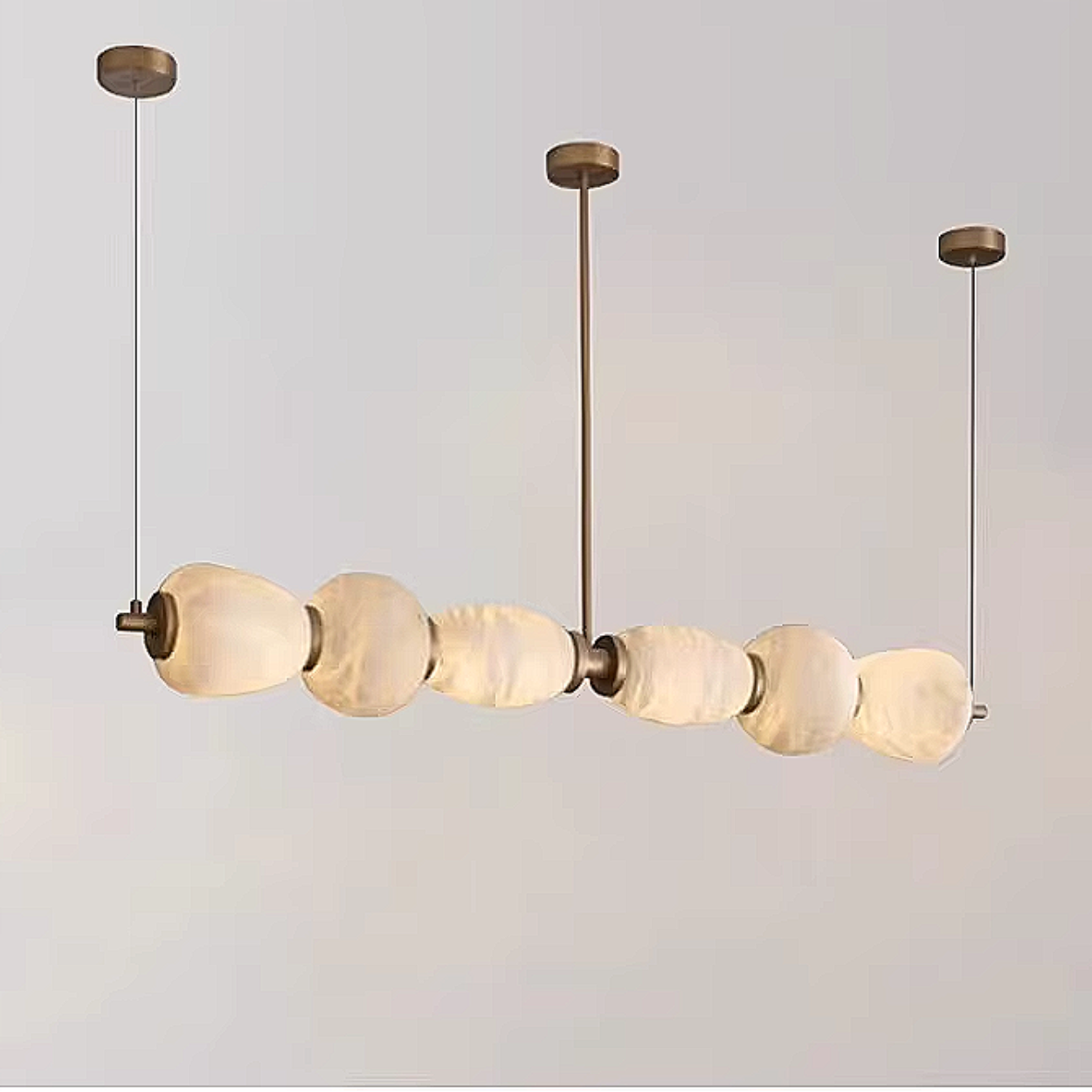 Natural alabaster pebble pendant light with organic stone texture and bronze linear frame – sculptural luxury chandelier by LINKORI
