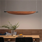 Japandi pendant light above a wooden kitchen island, featuring curved walnut design and soft LED glow