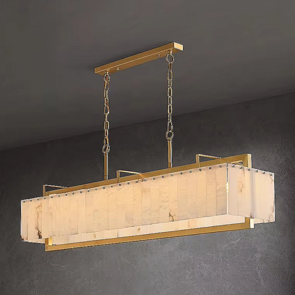 Gold alabaster linear pendant light fixture hanging above dining room table with modern contemporary decor