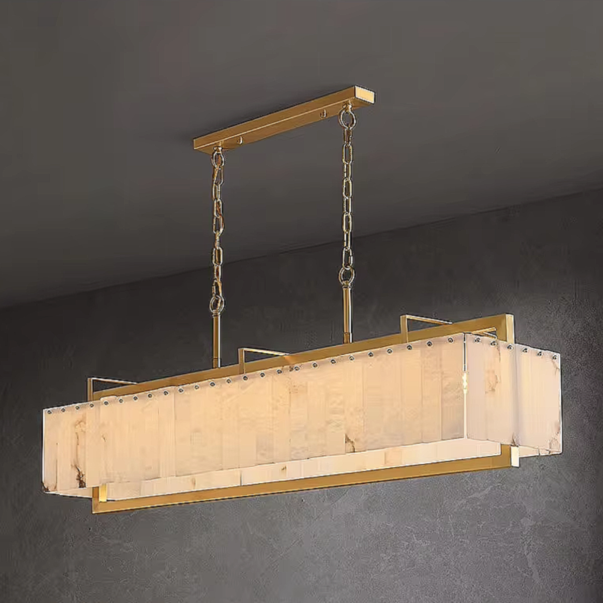 Gold alabaster linear pendant light fixture hanging above dining room table with modern contemporary decor