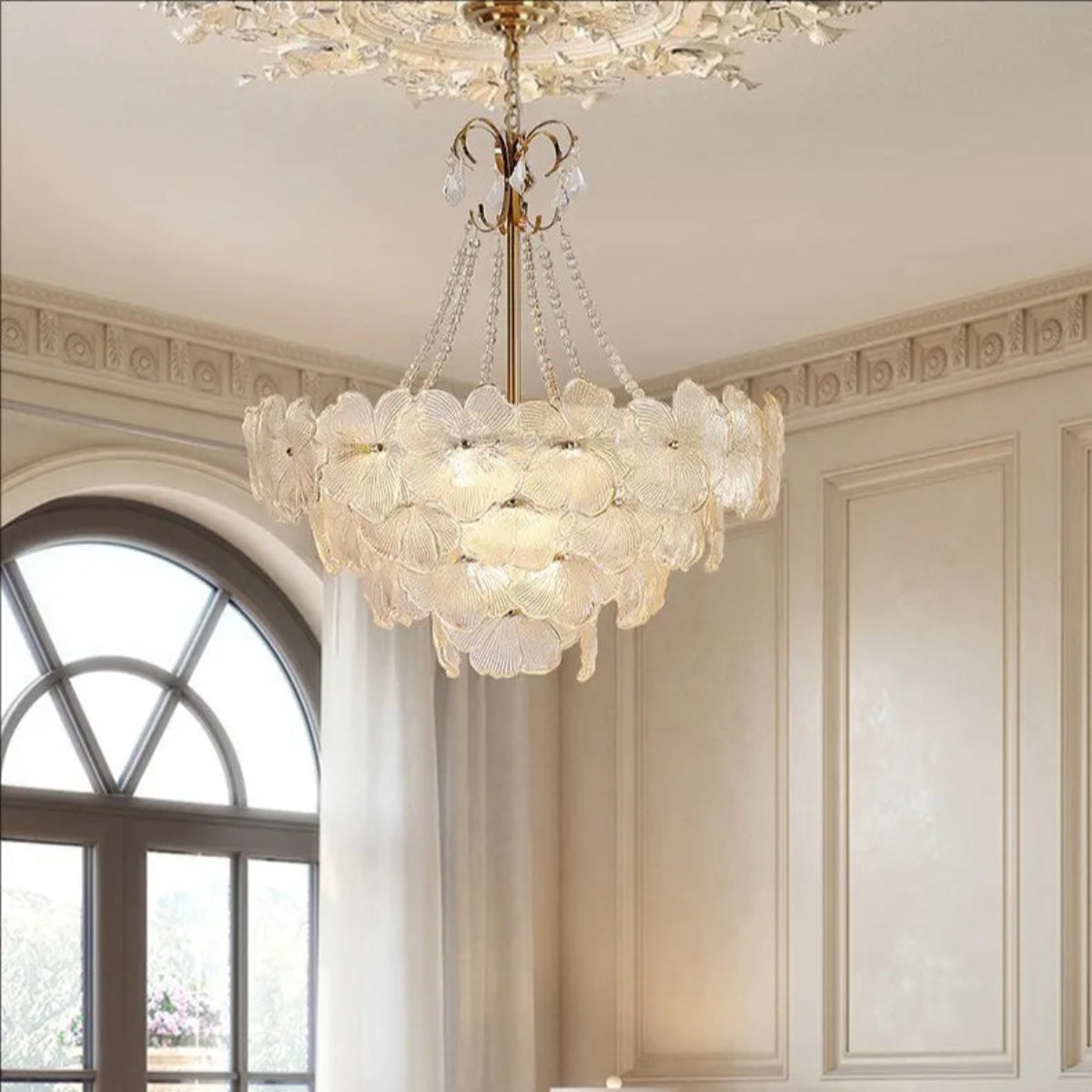 LINKORI SHALOLLYE chandelier lighting up a high-ceiling luxury living room with velvet sofas and golden decor.