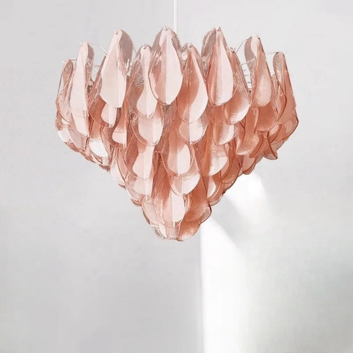 Sculptural pink glass chandelier with tiered design and blush-toned glow – vintage pendant light for dining rooms, dressing areas & romantic interiors