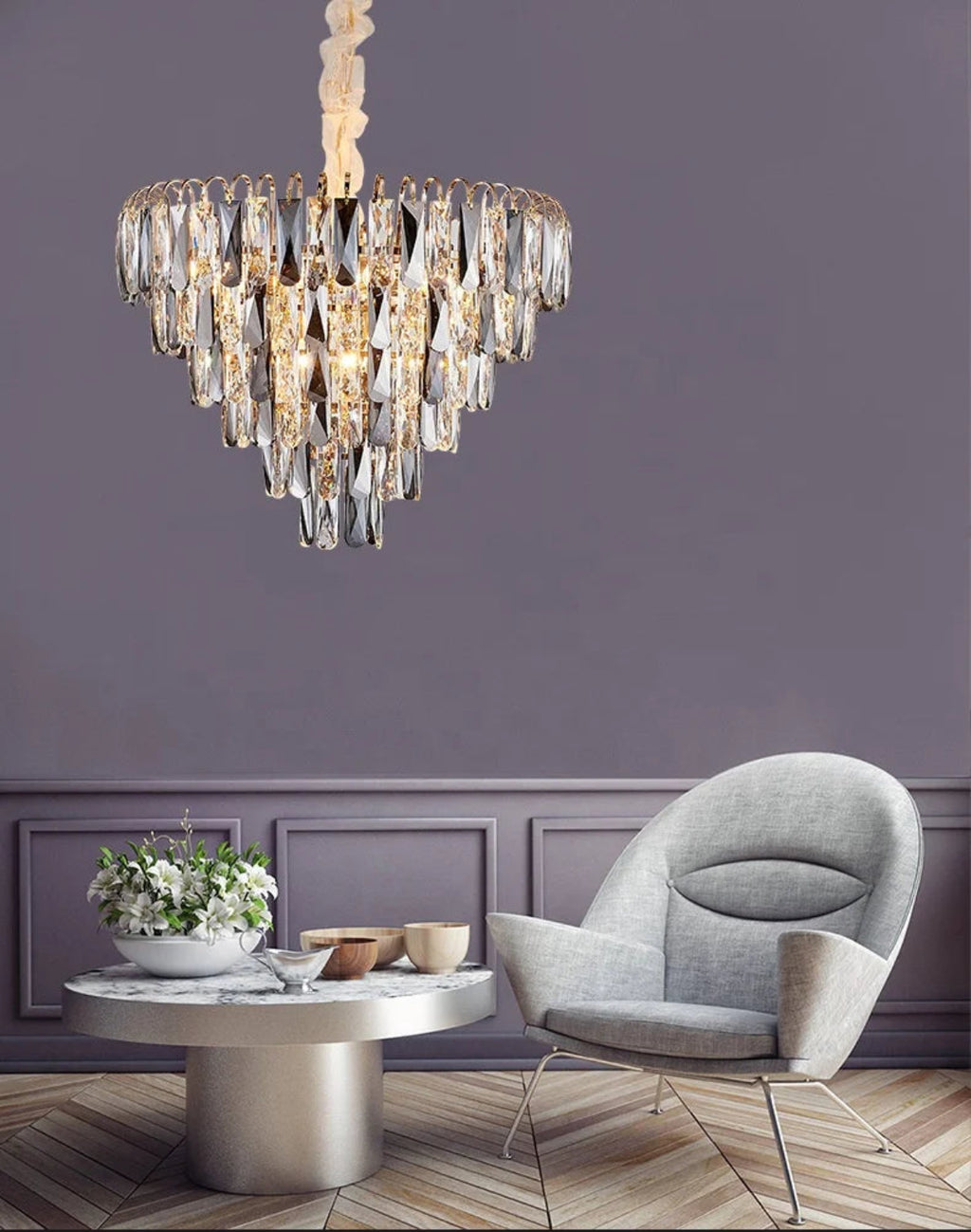 Luxury crystal chandelier complementing modern glam interior design with gold accents, marble surfaces, and contemporary furniture styling