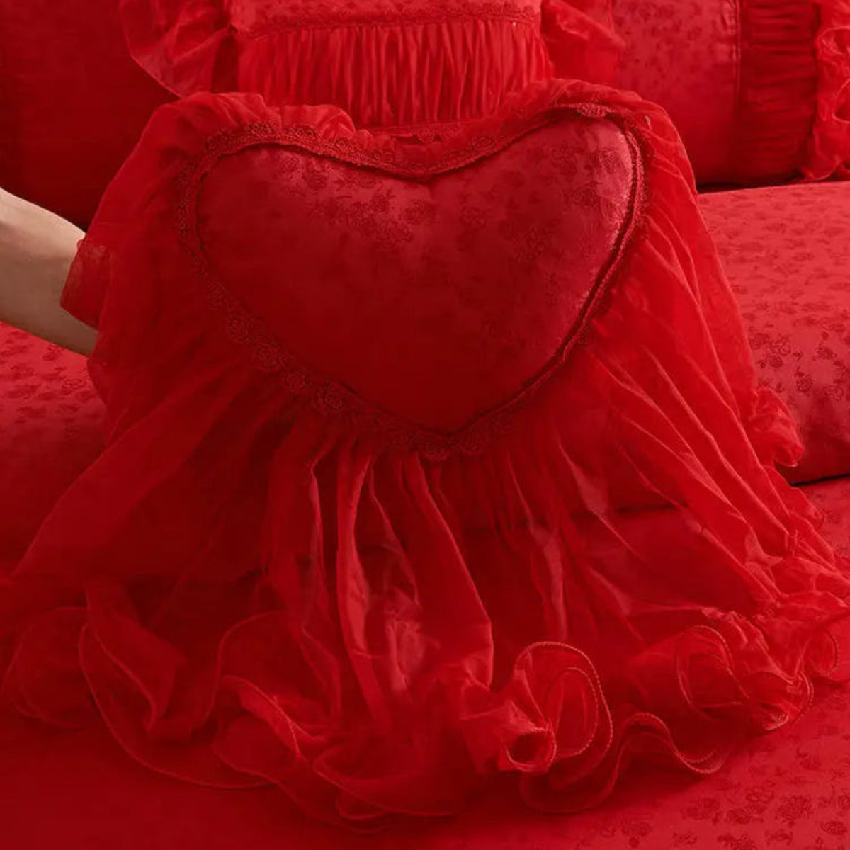 Heart-shaped lace pillow on red ruffle bedding — tatting lace, decorative cushion for romantic bedrooms, bridal/wedding bedding, vintage & shabby-chic style | LINKORI Racelet Red heart pillow view