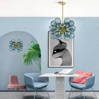 LINKORI FLOBUB chandelier in blue installed in vibrant, artistic café – playful design with floating glass globes