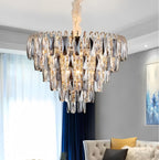Gold crystal chandelier with 6 E14 lights installed above dining table creating ambient lighting and elegant atmosphere in modern luxury dining room