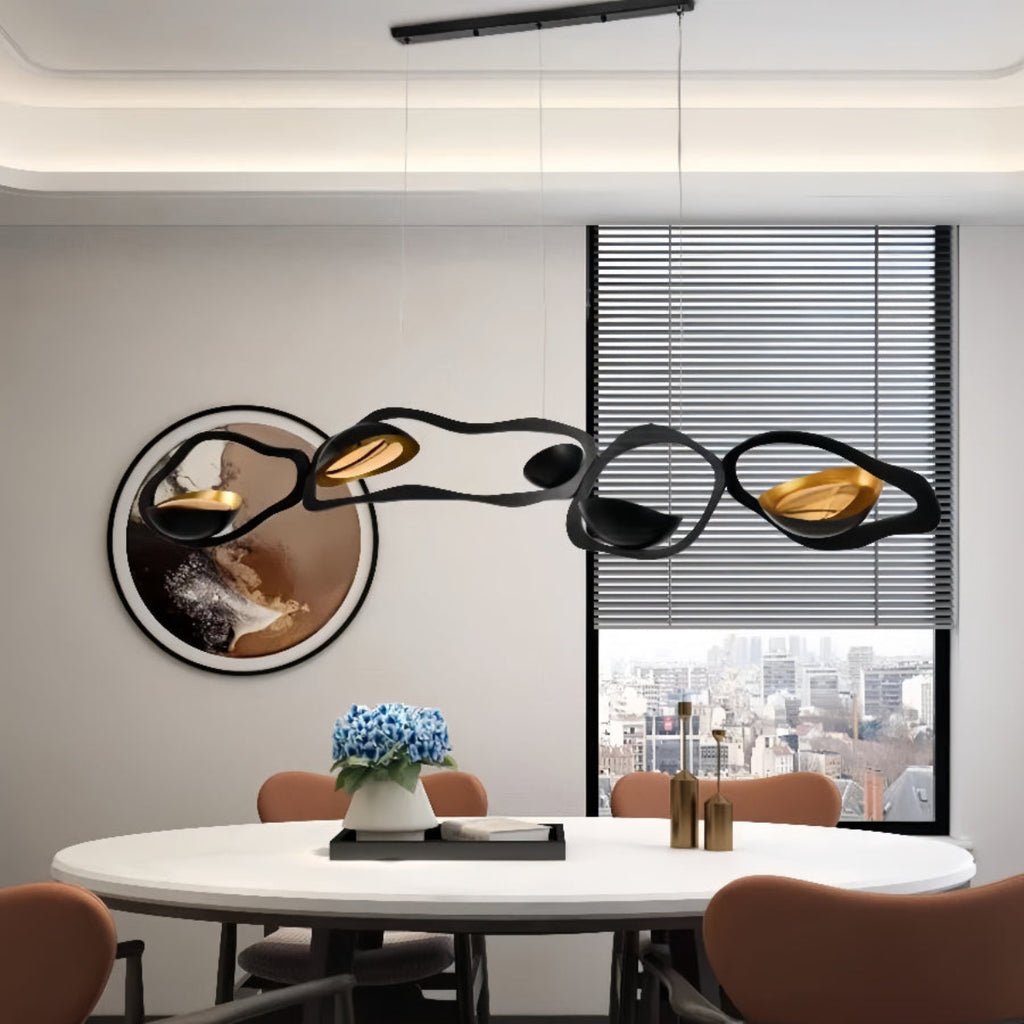 Luxury Ripple LED Pendant Light over Modern Dining Table — black and gold chandelier accenting sleek interior