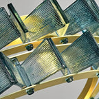 Close-up of faceted glass panels and brushed gold metal frame on PRUTIKE chandelier – detailed craftsmanship and luxe finish