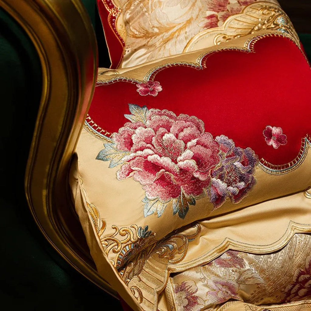 Luxury Egyptian cotton ivory bedding with red floral embroidery patterns for designer interiors