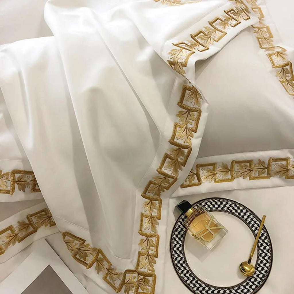 Designer white & gold bedding set – embroidered Egyptian cotton duvet cover with pillow shams for modern luxury homes.
