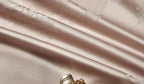 High-quality 1200TC cotton satin bedding with intricate champagne damask patterns and couture trim borders