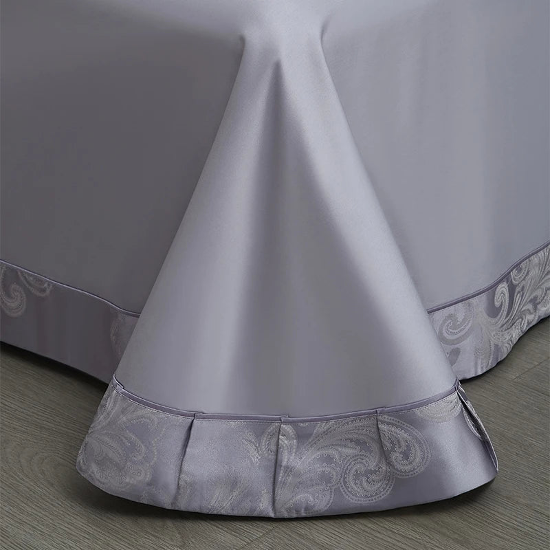 Premium cotton satin duvet cover displaying elegant lavender damask jacquard motifs with coordinating trim