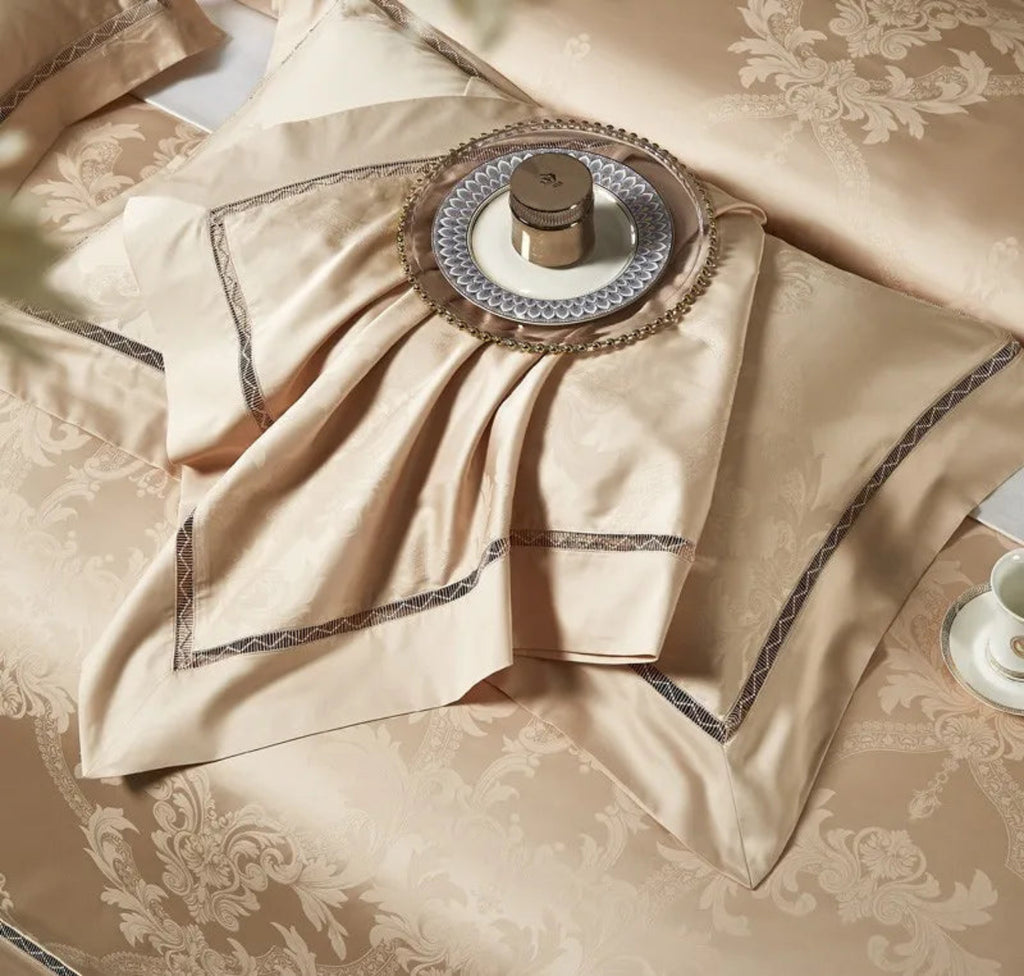 Ultra-luxury cotton satin duvet cover displaying elegant warm gold damask jacquard motifs with designer trim