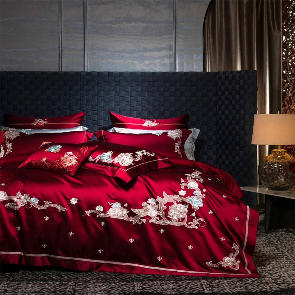 Luxury hotel-style red bedding with delicate embroidered florals on silky soft cotton fabric