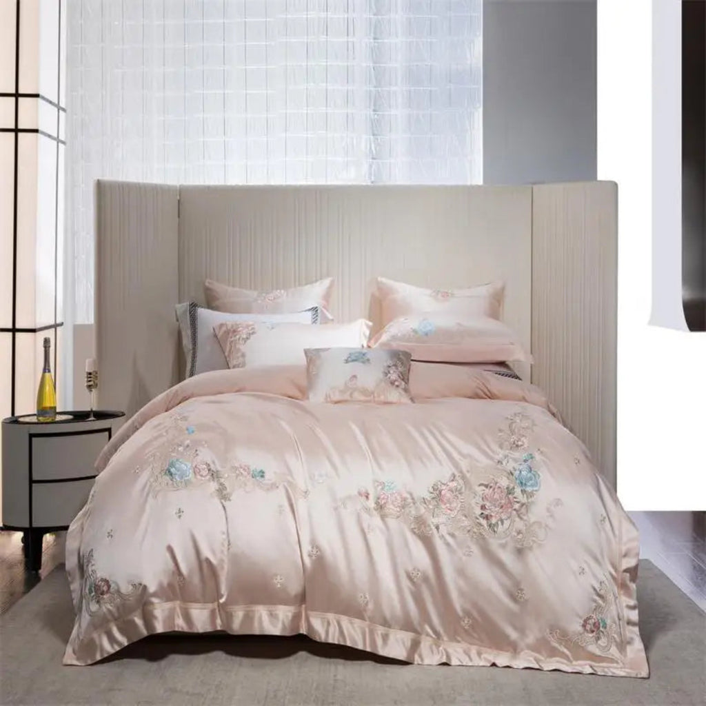 Luxury hotel-style pink bedding with delicate embroidered florals on silky soft cotton fabric