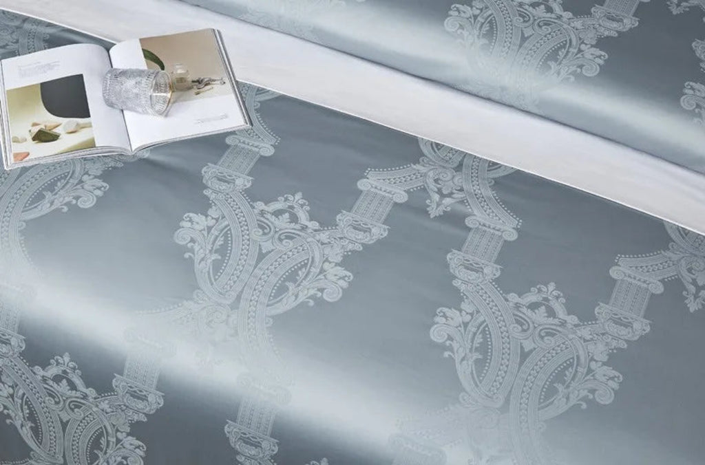 Ultra-luxury cotton satin duvet cover displaying elegant sky blue damask jacquard motifs with designer trim