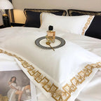 White designer bedding with gold embroidered border – luxury Egyptian cotton duvet cover set for timeless elegance.