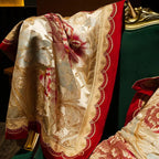 Embroidered ivory floral bedding with intricate red botanical motifs, feminine bedroom design