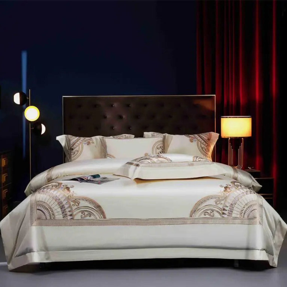 Ivory gold geometric duvet cover set with Art Deco embroidered border on luxury hotel bed