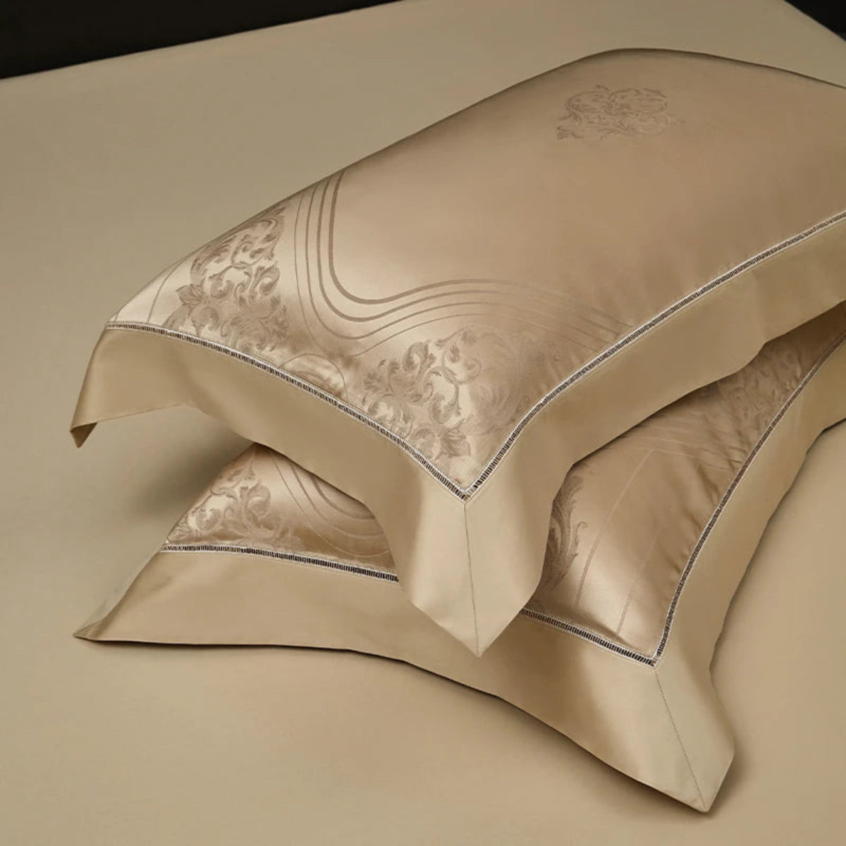 Elegant champagne gold cotton satin duvet cover with gallery-inspired geometric jacquard design and coordinating pillowcases.