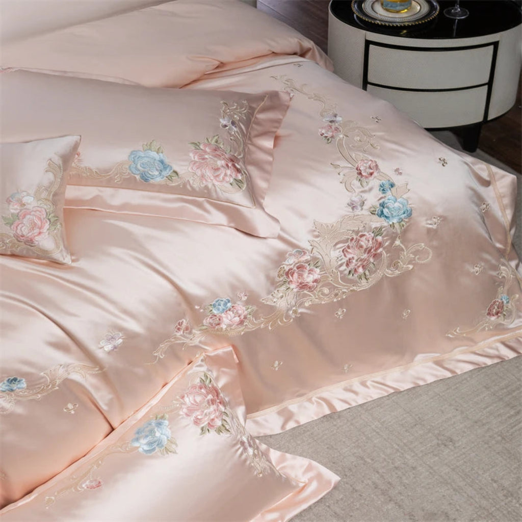 Luxury hotel-style pink bedding with delicate embroidered florals on silky soft cotton fabric