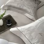 Modern bedroom styled with silver grey floral jacquard duvet cover set in satin and Egyptian cotton