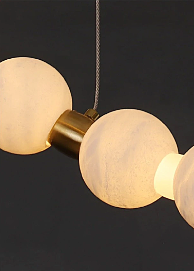Spanish alabaster orb bead detail with brushed gold brass connector – handcrafted natural stone chandelier close-up | LINKORI AURELIA