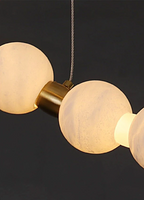 Spanish alabaster orb bead detail with brushed gold brass connector – handcrafted natural stone chandelier close-up | LINKORI AURELIA