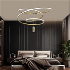 Modern luxury bedroom lit by gold 3-ring LED chandelier — dimmable triple ring pendant above bed, adjustable height, soft warm white | LINKORI BLANGCHI