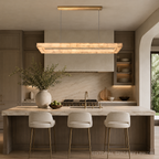 Spanish alabaster linear chandelier with a brass canopy above a quartzite island in a luxury dark wood kitchen – LINKORI BASPEAQ