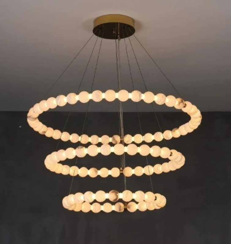alabaster chandelier in daylight — Spanish alabaster orbs on 
brushed gold 3-tier ring frame, soft natural translucent glow, high ceiling fixture | LINKORI AURELIA