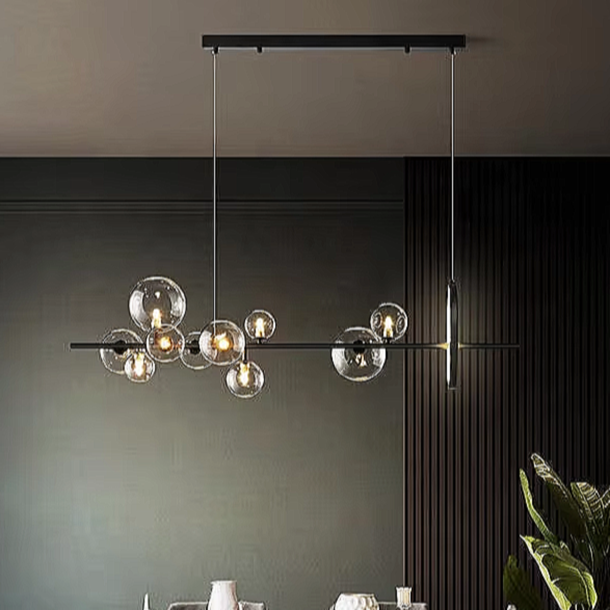 Sculptural linear glass chandelier with black frame suspended above a modern dining room — perfect for architectural and minimalist interiors.