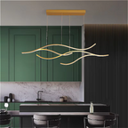 Contemporary kitchen in black and deep green tones with LINKORI CHULLENG S. brushed gold LED chandelier adding a sculptural modern accent.