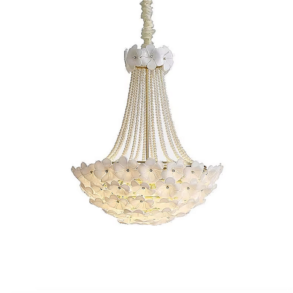 Studio-style image of a romantic floral chandelier against a white background, featuring pearl strand details and intricate white flower embellishments.


