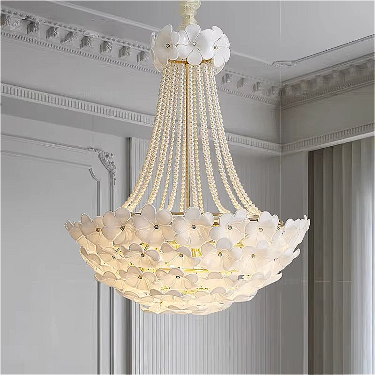 Full and close-up view of a luxury floral chandelier with pearl-like strands and white flower accents, creating a romantic statement in a high-ceiling living room.