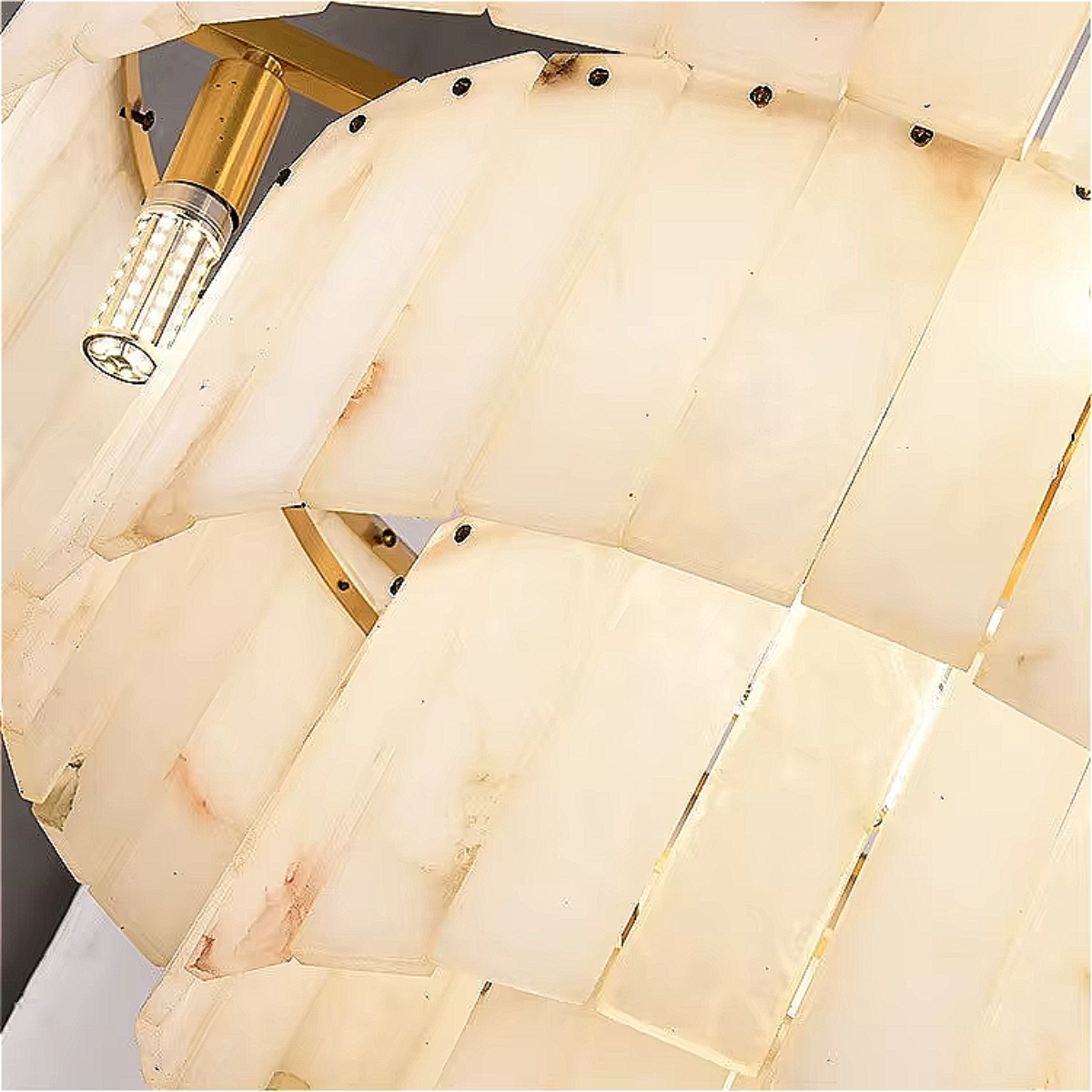  Close-up of natural marble shade with soft veining and warm glow, showing the elegant stone texture and gold-accented edge.

