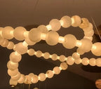 Illuminated two-tier alabaster globe ring chandelier with natural stone spheres, brass details, and adjustable suspension – LINKORI AURELIA
