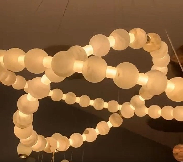 Illuminated two-tier alabaster globe ring chandelier with natural stone spheres, brass details, and adjustable suspension – LINKORI AURELIA