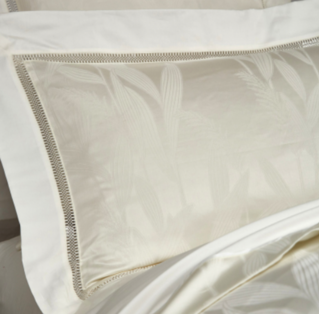 Close-up of subtle leaf jacquard pattern on ivory Egyptian cotton pillowcases — luxurious detail of LINKORI Lilela.