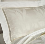 Close-up of subtle leaf jacquard pattern on ivory Egyptian cotton pillowcases — luxurious detail of LINKORI Lilela.
