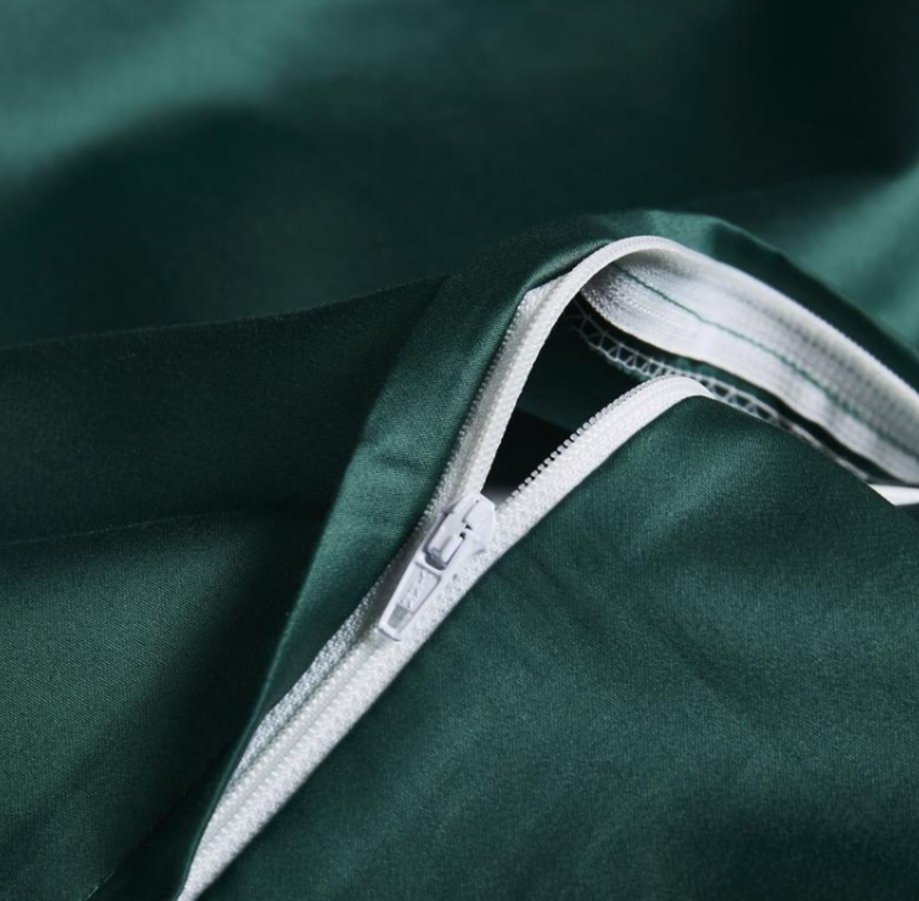 Concealed zipper detail on deep green embroidered duvet cover – smooth finish with elegant function