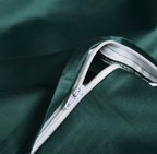 Concealed zipper detail on deep green embroidered duvet cover – smooth finish with elegant function