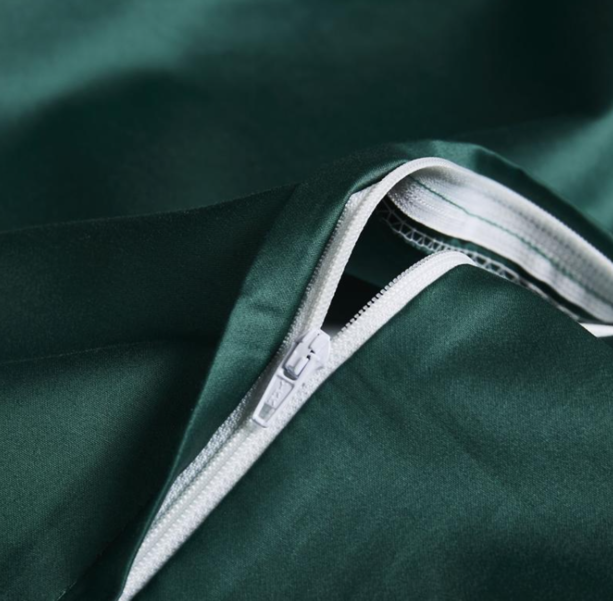 Concealed zipper detail on deep green embroidered duvet cover – smooth finish with elegant function