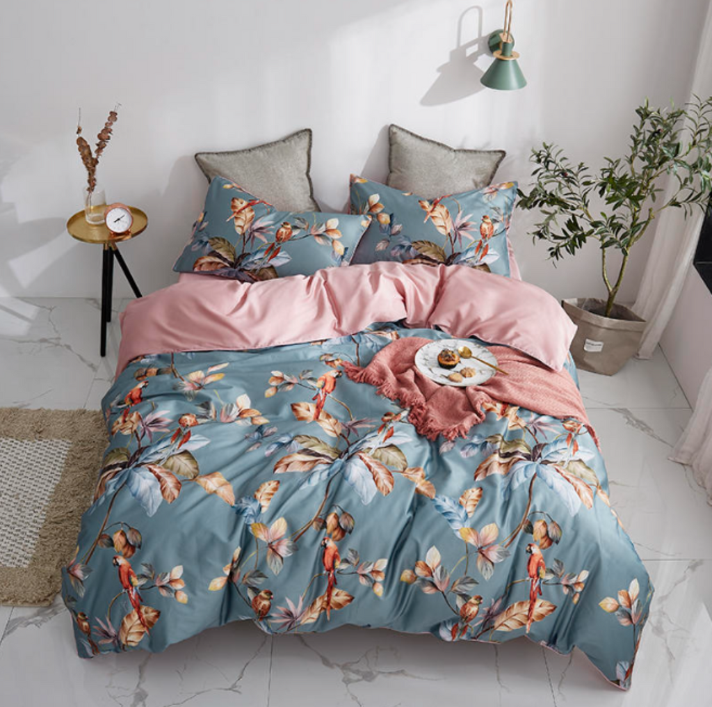 Top view of LINKORI Livelic 4-piece tropical duvet cover set with blue and pink tones, featuring floral and parrot patterns