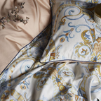 Folded edge of the paisley duvet cover revealing warm beige cotton lining — showcasing fabric contrast and inner softness.


